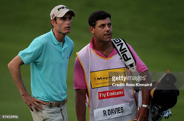 Rhys Davies of Wales waits with his caddie on the 18th hole during the second round of the Maybank Malaysia Open at the Kuala Lumpur Golf & Country...