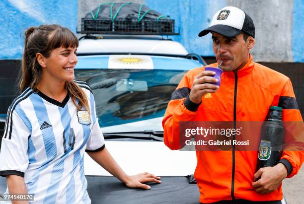 Argentina Fans who have been traveling for 32 months, Tomy and Mariana pose with their car on June 14, 2018 in Moscow, Russia. They left Argentina 32...