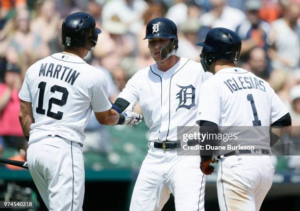 JaCoby Jones of the Detroit Tigers celebrates with Leonys Martin of the Detroit Tigers and Jose Iglesias of the Detroit Tigers after hitting a...