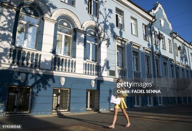 Woman walks in a street of Voronezh on June 14 during the Russia 2018 World Cup football tournament.