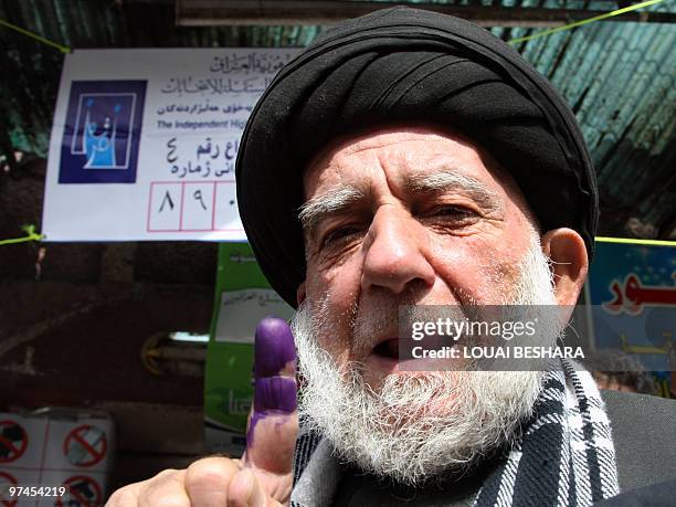 An Iraqi refugee shows his ink-stained finger after casting vote for the Iraqi general election a a polling station in Damascus on March 5, 2010....