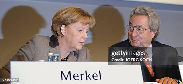 German Chancellor Angela Merkel and head of the Federation of German Employers' Associations Dieter Hundt address a press conference after the annual...