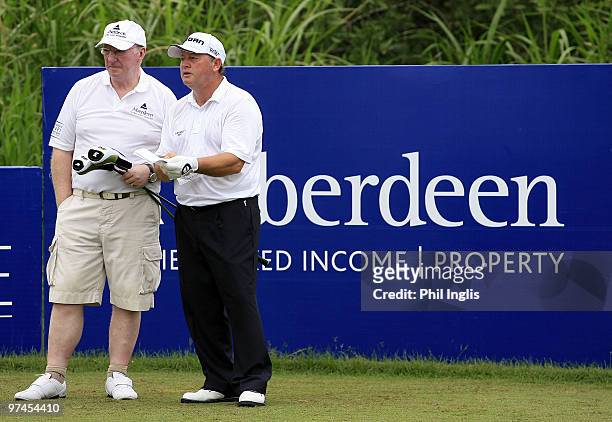 Ian Woosnam of Wales with his caddie, snooker ace Dennis Taylor in action during the first round of the Aberdeen Brunei Senior Masters presented by...