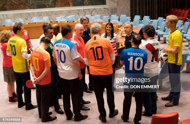 Members of the Security Council gather together to pose for photos wearing World Cup uniforms June 14, 2018 at the United Nations in New York.