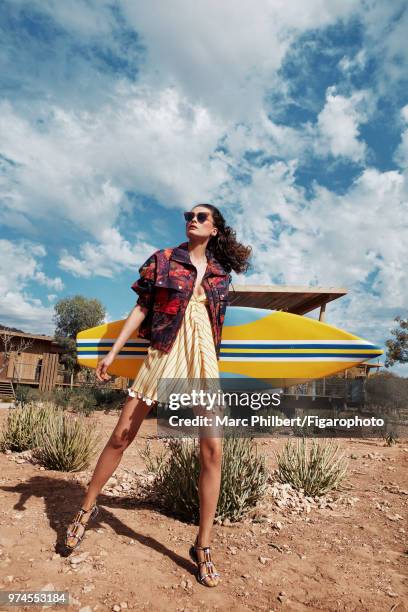 Model Elena Melnik poses at a fashion shoot for Madame Figaro on November 29, 2017 in Taghazout, Morocco. Jacket , dress . Sunglasses , sandals ....