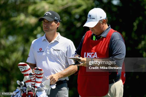 Kevin Kisner of the United States waits with his caddie on the 11th tee during the first round of the 2018 U.S. Open at Shinnecock Hills Golf Club on...