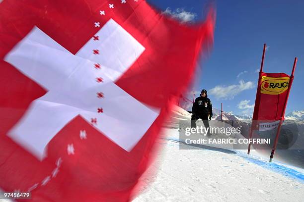 Swiss flag is blown by wind on March 5, 2010 in Crans-Montana's slope "Nationale" as the scheduled World Cup alpine Women super-combined event has...