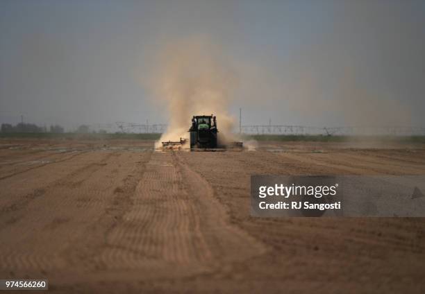 Farmer plows his field near Alamosa, Colorado on June 10, 2018. The area is experiencing a drought.