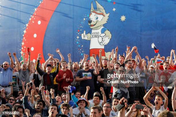 Supporters celebrate during the FIFA World Cup 2018 match between Russia and Saudi Arabia on June 14, 2018 at Fan Fest zone in Saint Petersburg,...