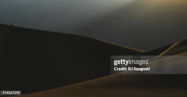 Women watch the sun rise at the Great Sand Dunes National Park on June 11, 2018 near Alamosa, Colorado.