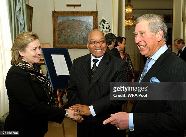 Britain's Prince Charles, Prince of Wales stands next to South African President Jacob Zuma as he shakes hands with Polly Courtice the Director for...