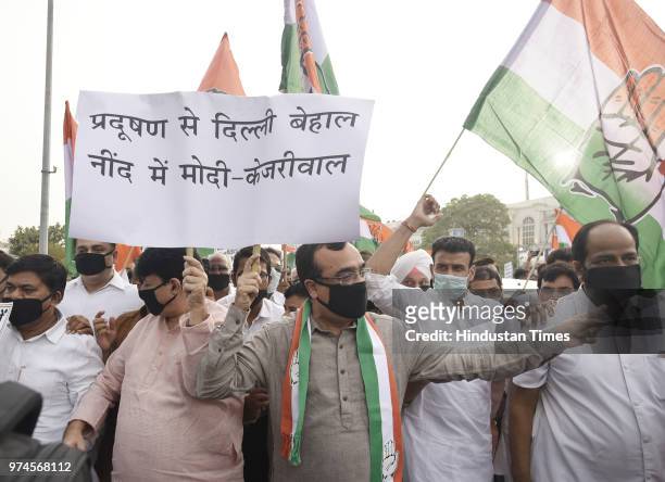 President Ajay Maken leads a protest march on dangerous condition of pollution in the capital at Rajiv Chowk Metro Station Gate No. 2, on June 14,...