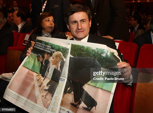 Gianni Alemanno, Mayor of Rome, shows a newspaper to the journalist during the presentaton for the candidature for Rome 2020 Summer Olympic Games at...