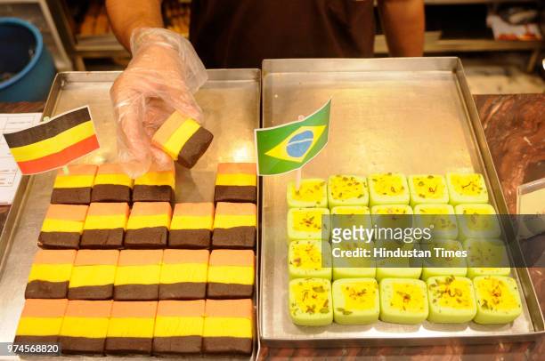 Sweets with German and Brazilian flag-coloured at Balaram Mullick & Radharaman Mullick Sweets Shop to celebrate FIFA World Cup Football Tournament at...