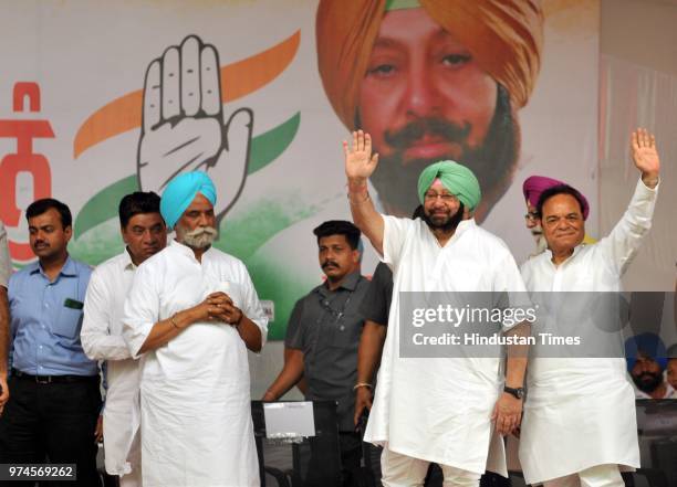 Punjab Chief Minister Captain Amarinder Singh along with Lok Sabha MP Chaudhary Santokh Singh during a rally at Shahkot on June 14, 2018 in...