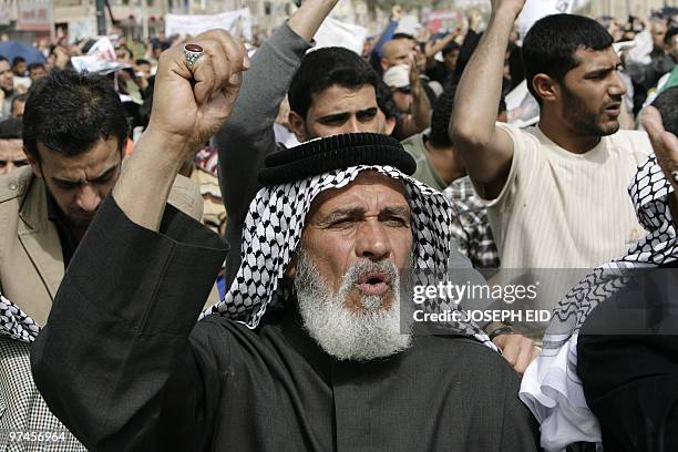 Iraqi Shiite Muslims shout slogans in support of Shiite cleric Moqtada al-Sadr as they attend Friday prayers in Baghdad's Shiite bastion of Sadr City...