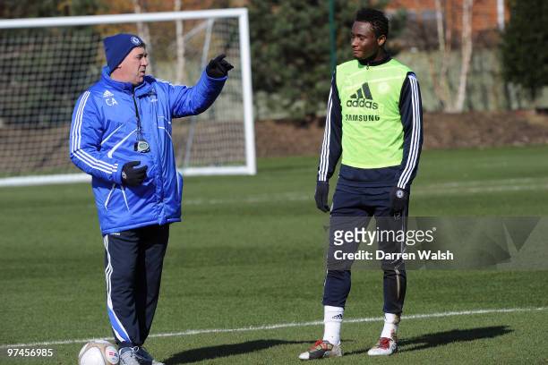 Carlo Ancelotti and John Mikel Obi of Chelsea during a training session at the Cobham Training ground on March 5, 2010 in Cobham, England.