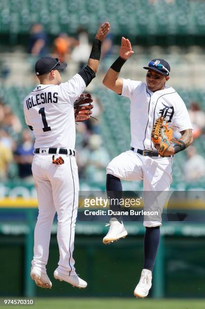 Jose Iglesias of the Detroit Tigers celebrates with Leonys Martin of the Detroit Tigers after a 3-1 win over the Minnesota Twins at Comerica Park on...