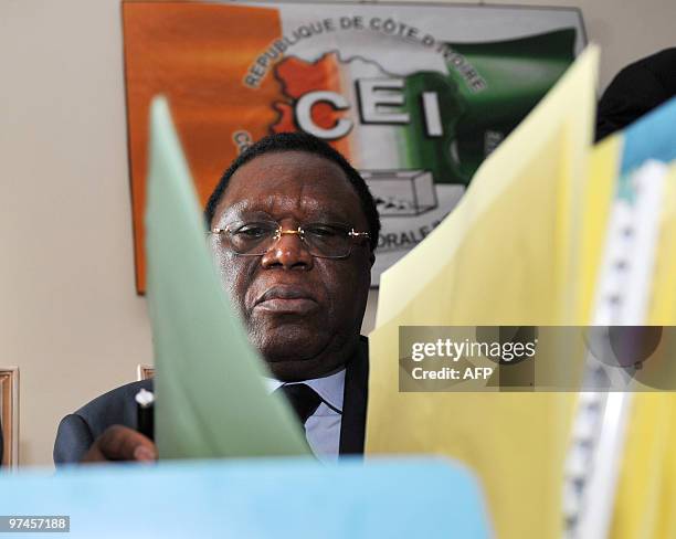 The new president of the Independent Electoral Commission , Youssouf Bakayoko poses at the CEI's headquarters, where he arrived for the handover...