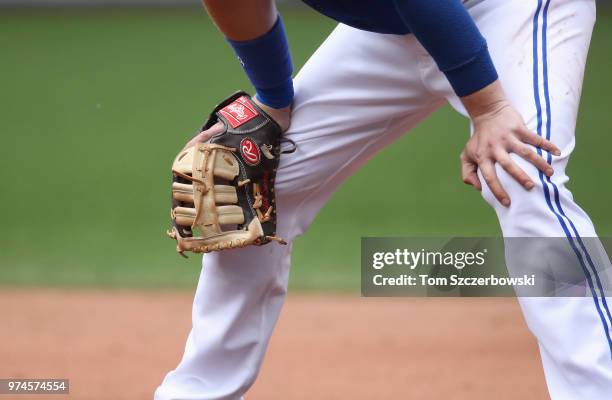 Detailed view of the glove worn by Justin Smoak of the Toronto Blue Jays as he gets set to play defense at his position at first base during MLB game...