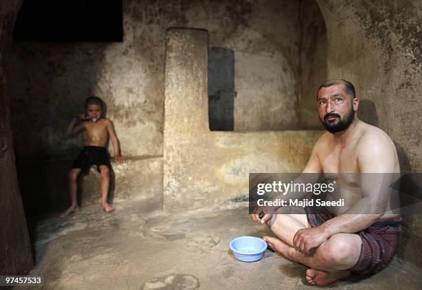 Afghan men and boys bathe in the hot room at a hammam on March 5, 2010 in Herat, Afghanistan. It is traditional for Afghans to visit the hammam on a...