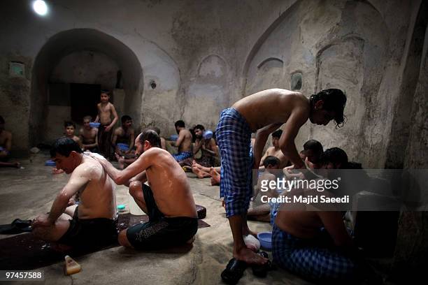 Afghan men and boys bathe in the hot room at a hammam on March 5, 2010 in Herat, Afghanistan. It is traditional for Afghans to visit the hammam on a...