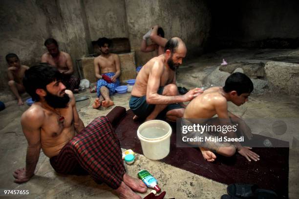 Afghan men and boys bathe in the hot room at a hammam on March 5, 2010 in Herat, Afghanistan. It is traditional for Afghans to visit the hammam on a...