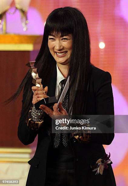 Actress Kimiko Yo holds a trophy upon receiving the award for best supporting actress for the film "Dear Doctor" during the 33rd Japan Academy Aawrds...