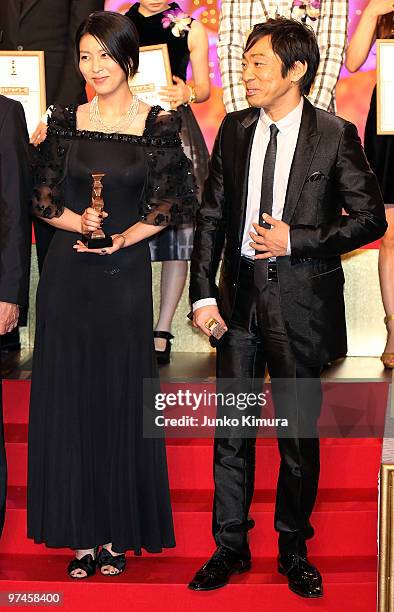 Actress Takako Matsu and actor Teruyuki Kagawa hold trophies during the 33rd Japan Academy Aawrds at Grand Prince Hotel New Takanawa on March 5, 2010...