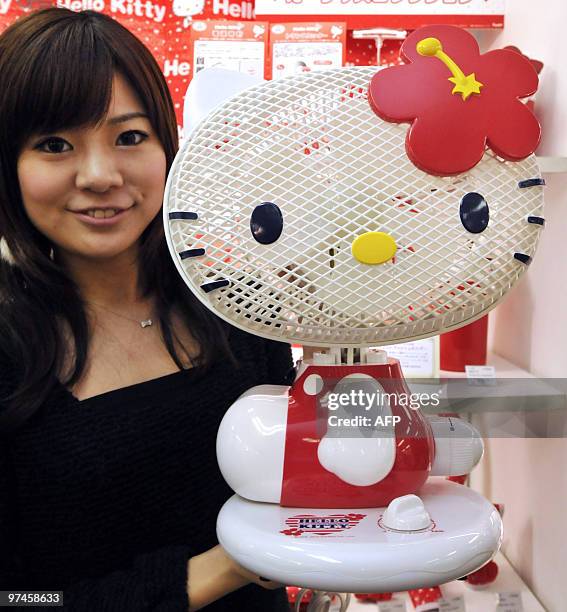 Sanrio employee displays a new electric fan shaped as character 'Hello Kitty' in Tokyo on March 1 expected to go on the market in April. Extremely...