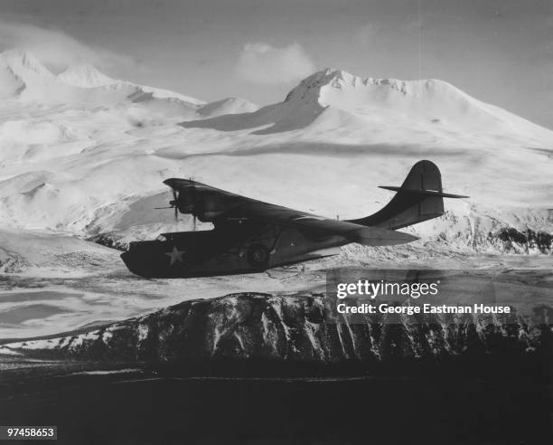 Military seaplane flying somewhere in the Aleutian Island region, 1943.