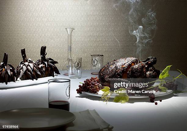 burnt chicken & artichokes on a nice dining table - smoking meat stock pictures, royalty-free photos & images