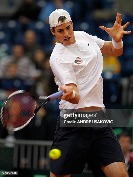 John Isner of the US returns the ball to Serbia's Viktor Troicki during their Davis Cup World Group first round tennis match on March 5 at Belgrade...