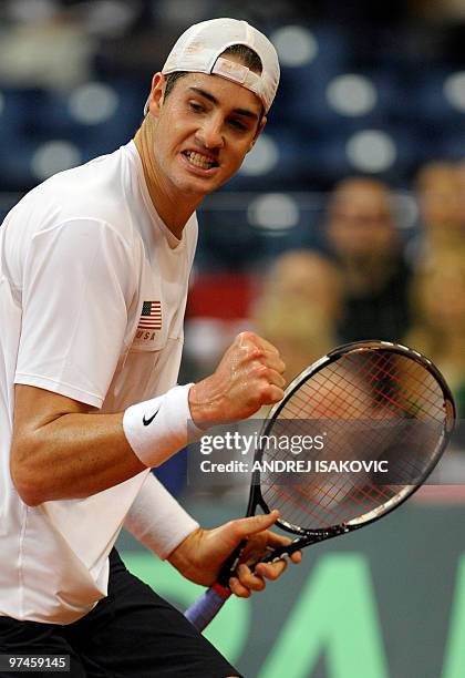 John Isner of the US reacts after scoring against Serbia's Viktor Troicki during their Davis Cup World Group first round tennis match on March 5 in...