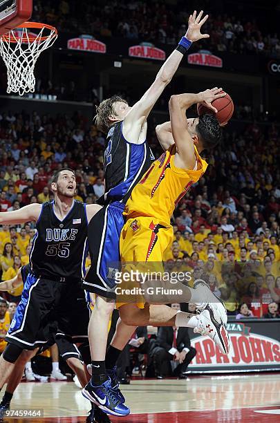 Greivis Vasquez of the Maryland Terrapins drives to the hoop against Kyle Singler of the Duke Blue Devils at the Comcast Center on March 3, 2010 in...