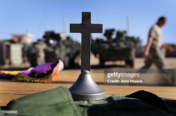 Cross stands on a table following a Catholic communion for U.S. Soldiers on March 5, 2010 at a small American combat outpost in Sha-Wali-Kot in...