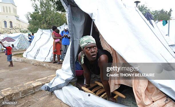 Haitian woman looks out of her tent on March 5, 2010 in Port-au-Prince. A new round of food distributions will begin March 6 in quake-hit Haiti, with...