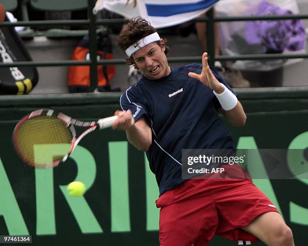 Dominican Jose Hernandez returns the ball to Uruguayan Pablo Cuevas during their Copa Davis game in Santo Domingo, March 5, 2010. Cuevas won 6-2, 7-5...