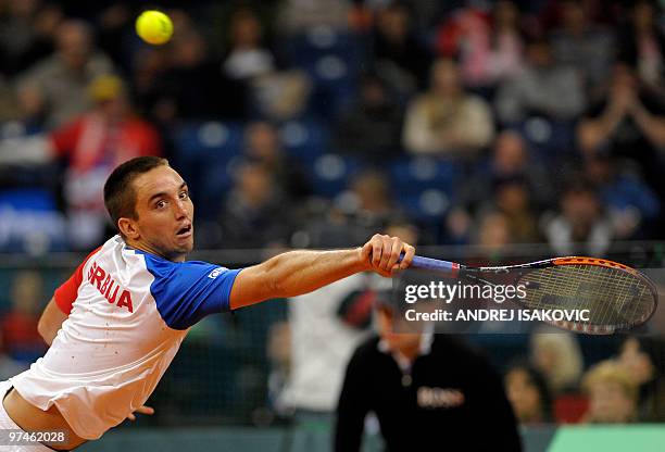 Serbia's Viktor Troicki returns the ball to John Isner of the US during their Davis Cup World Group first round tennis match on March 5 in Belgrade...