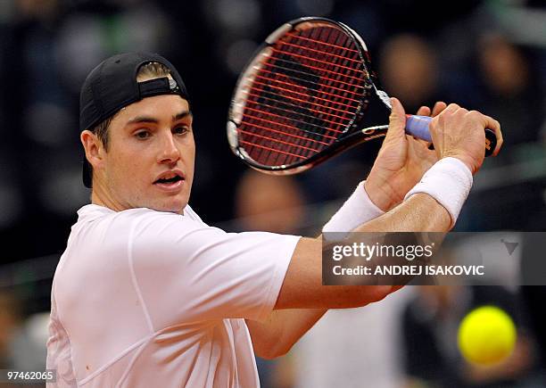 John Isner of the US returns the ball to Serbia's Viktor Troicki during their Davis Cup World Group first round tennis match on March 5 in Belgrade...