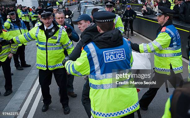 Police officers restrain a member of the English Defence League during a demonstration in support of Dutch MP Geert Wilders on March 5, 2010 in...