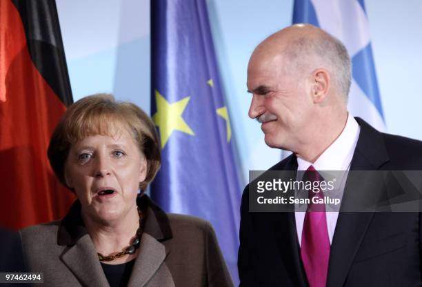 German Chancellor Angela Merkel and Greek Prime Minister George Papandreou depart after speaking to the media fllowing talks at the Chancellery on...