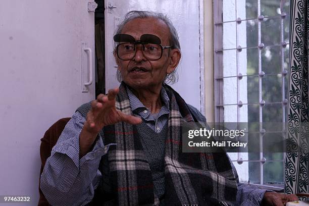 Lal of New Delhi sits with the machine, a green AC which he created by passing air through ice, speaks about his invention in Delhi on March 3, 2010.