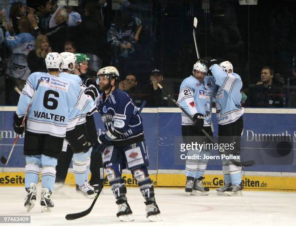 Francois Fortier of Hamburg celebrates with his team mates after scoring his team's first goal during the DEL match between Hamburg Freezers and...