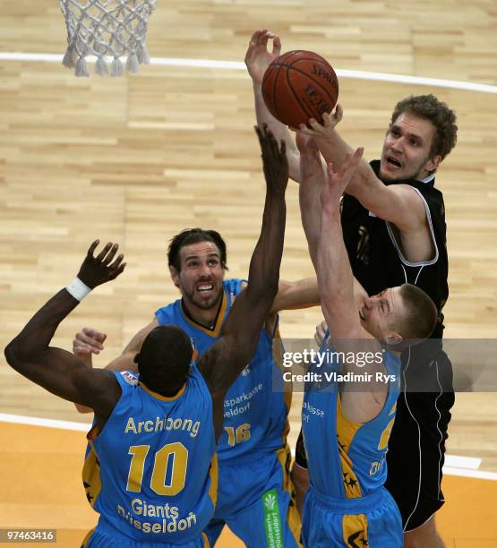 Anatoly Kashirov of MBC jumps up for a rebound with Giant players during the Beko Bundesliga game between Giants Duesseldorf and Mitteldeutscher BC...