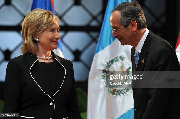 Secretary of State Hillary Rodham Clinton and Guatemalan President Alvaro Colom chat as they pose for pictures during a press conference at the...