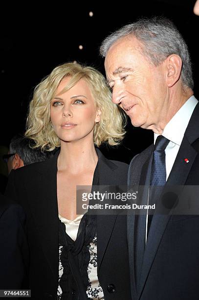 Charlize Theron and Bernard Arnault attend the Christian Dior Ready to Wear show as part of the Paris Womenswear Fashion Week Fall/Winter 2011 at...