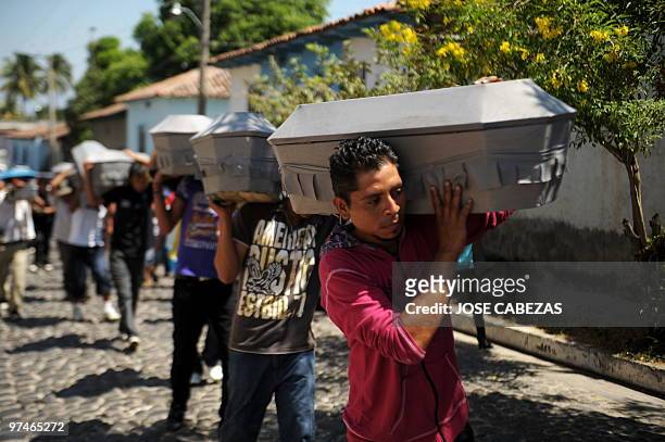 Relatives carry the coffins of the 26 members of the Aleman and Rivera families slained during the civil war, for their burial in Suchitoto, 44 km...