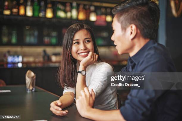 Multi Ethnic Couple Waiting For The Drink In The Bar High-Res Stock Photo