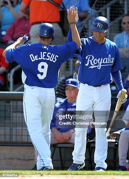 David DeJesus of the Kansas City Royals is congratulated by teammate Rick Ankiel after scoring a run against the Texas Rangers during the first...